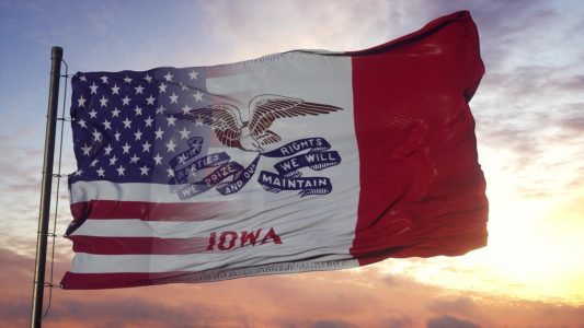 Iowa And Usa Flag On Flagpole. Usa And Iowa Mixed Flag Waving In